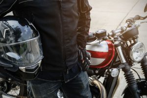 Biker wear jacket suit hold helmet with retro motorcycle