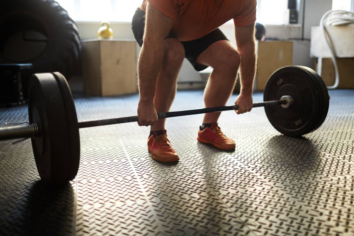 Bodybuilder lifting heavy weight in gym